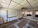 A living room featuring wood paneling and damaged drywall and drop ceiling at 2100 Pass A Grille Way, St Pete Beach, FL 33706