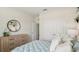 Relaxing bedroom with natural-wood furniture and a view of the large closet behind the bed at 2263 Rikkola Ln, Wesley Chapel, FL 33543