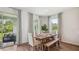 Cozy dining area with a rustic wooden table, bench seating, and sliding door to a patio at 2263 Rikkola Ln, Wesley Chapel, FL 33543