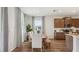 Dining area with a table set for six, modern lighting, and a view of the backyard at 2286 Sienna Spruce St, Wesley Chapel, FL 33543