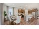 Dining area with a wooden table, seating for six, and modern lighting at 2286 Sienna Spruce St, Wesley Chapel, FL 33543
