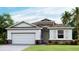 Charming one-story home with stone accents, a two-car garage, and well-manicured landscaping at 2286 Sienna Spruce St, Wesley Chapel, FL 33543