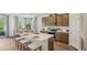 Modern kitchen with stainless steel appliances, white countertops, and a breakfast bar at 2286 Sienna Spruce St, Wesley Chapel, FL 33543