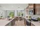 Modern open concept kitchen with stainless steel appliances and a view of the dining area and backyard at 2286 Sienna Spruce St, Wesley Chapel, FL 33543