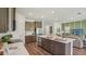 Bright kitchen with a large island, stainless steel appliances, and an open view of the living area at 2286 Sienna Spruce St, Wesley Chapel, FL 33543