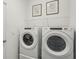 Well-lit laundry area featuring side-by-side Whirlpool washer and dryer and wire shelving at 2286 Sienna Spruce St, Wesley Chapel, FL 33543