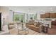 Open-concept living room flowing into the kitchen with lots of windows for natural light at 2286 Sienna Spruce St, Wesley Chapel, FL 33543