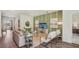 Bright living room with modern decor, a green accent wall, and comfortable seating arrangement at 2286 Sienna Spruce St, Wesley Chapel, FL 33543