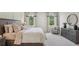 Tranquil bedroom featuring large windows and a plush king bed, creating a serene and relaxing retreat at 2286 Sienna Spruce St, Wesley Chapel, FL 33543