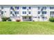 A well-kept backyard of an apartment complex featuring manicured lawns and a cozy, enclosed patio area at 2452 Brazilia Dr # 18, Clearwater, FL 33763