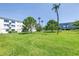 Expansive green lawn with mature trees in the backyard offers scenic views at 2452 Brazilia Dr # 18, Clearwater, FL 33763