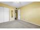 Cozy bedroom with ceiling fan, carpeted floor and access to additional room with mirror at 2452 Brazilia Dr # 18, Clearwater, FL 33763