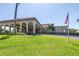 Attractive building exterior with a manicured lawn, arched entryway, and American flag at 2452 Brazilia Dr # 18, Clearwater, FL 33763