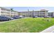 Exterior view of the building with neatly kept grounds, lush grass, and convenient parking spots at 2452 Brazilia Dr # 18, Clearwater, FL 33763