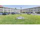 Polynesian community building with lush green lawns, ample parking, and easy access at 2452 Brazilia Dr # 18, Clearwater, FL 33763