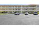 A condominium building showcasing multiple levels and private balconies with parking spaces out front at 2452 Brazilia Dr # 18, Clearwater, FL 33763