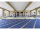 Elegant building entrance featuring arched doorways, tan columns, and blue asphalt with yellow parking stripes at 2452 Brazilia Dr # 18, Clearwater, FL 33763