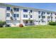 Rear building view showcasing well-maintained lawn and screened-in patios at 2452 Brazilia Dr # 18, Clearwater, FL 33763