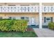 Inviting condo exterior with a well-kept lawn, garden foliage, and clearly marked unit numbers at 2452 Brazilia Dr # 18, Clearwater, FL 33763