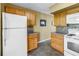 Functional kitchen space showcases light wood cabinets, tiled backsplash, and modern appliances for easy cooking at 2452 Brazilia Dr # 18, Clearwater, FL 33763