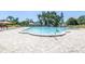 Large outdoor swimming pool with surrounding deck and lounge chairs at 2452 Brazilia Dr # 18, Clearwater, FL 33763