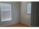 Neutral bedroom featuring parquet floors and dual windows at 2603 Mary Sue Sw St, Largo, FL 33774