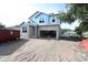 Exterior view of new construction home with blue weather barrier wrap and cinder block first story at 3108 W Varn Ave, Tampa, FL 33611