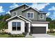 Charming two-story home featuring a clean white stucco first floor and board and batten siding on the second floor at 3108 W Varn Ave, Tampa, FL 33611
