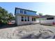 Exterior view of new construction home with blue weather barrier wrap and cinder block first story at 3108 W Varn Ave, Tampa, FL 33611