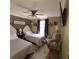 Bright bedroom featuring two beds, a ceiling fan, an accent brick wall and an accent chair at 314 Bloomingfield Dr, Brandon, FL 33511