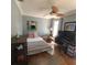 Cozy bedroom with a ceiling fan and a wooden desk with computer monitors at 314 Bloomingfield Dr, Brandon, FL 33511