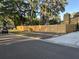 Street view of a modern home with a new wooden fence and manicured lawn at 314 Bloomingfield Dr, Brandon, FL 33511