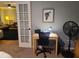 Functional home office with a desk, chair, fan, and view into living area, designed for productivity and comfort at 314 Bloomingfield Dr, Brandon, FL 33511