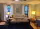 Inviting living room featuring a comfortable couch, bright windows, and stylish decor, perfect for Gathering gatherings at 314 Bloomingfield Dr, Brandon, FL 33511