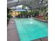 Inviting screened-in pool with a fountain, adjacent to a hot tub and dining area, perfect for outdoor relaxation at 314 Bloomingfield Dr, Brandon, FL 33511
