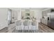 Elegant kitchen with a spacious island featuring bar seating and updated stainless steel appliances, ideal for entertaining at 32702 Winterwood Blvd, Wesley Chapel, FL 33543