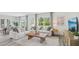 Bright living room boasts hardwood floors, modern decor, large windows, and an adjacent dining area at 32702 Winterwood Blvd, Wesley Chapel, FL 33543