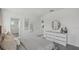 Spacious main bedroom with serene decor, a large bed, and ample natural light at 32702 Winterwood Boulevard Blvd, Wesley Chapel, FL 33543