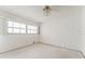 Bright bedroom featuring a ceiling fan, and natural light from a large window at 5 Marina Ter, Treasure Island, FL 33706
