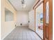 Entryway with patterned wallpaper and tile floors featuring a half-view of the exterior at 5 Marina Ter, Treasure Island, FL 33706