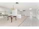 Spacious open-concept living room featuring tile and carpet flooring with a dining area at 5 Marina Ter, Treasure Island, FL 33706