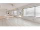 Sunroom with tile flooring and multiple windows overlooking the backyard, with an adjacent living space at 5 Marina Ter, Treasure Island, FL 33706