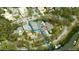 An aerial view shows a spacious estate featuring a tennis court, swimming pool, and access to the river at 5002 S Shore Crest Cir, Tampa, FL 33609