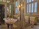 A luxurious bathroom with a unique sink, mirrored walls and natural light at 5002 S Shore Crest Cir, Tampa, FL 33609