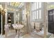 Bathroom featuring patterned tile ceiling and walls, ornate sconces, vessel sinks, and large mirrors at 5002 S Shore Crest Cir, Tampa, FL 33609