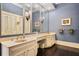 Stylish bathroom with dual sinks, large mirrors, chandelier lighting, and ample counter space at 5002 S Shore Crest Cir, Tampa, FL 33609