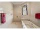 Luxurious bathroom with marble tile, a soaking tub, and walk-in shower at 5002 S Shore Crest Cir, Tampa, FL 33609