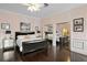 Bedroom with wood floors, mirrored closets, decorative art and ceiling fan at 5002 S Shore Crest Cir, Tampa, FL 33609