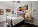 Bedroom with wood floors, window with blind, and decorated wall at 5002 S Shore Crest Cir, Tampa, FL 33609