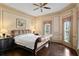 Bedroom features hardwood floors, windows with decorative treatments, and a ceiling fan at 5002 S Shore Crest Cir, Tampa, FL 33609
